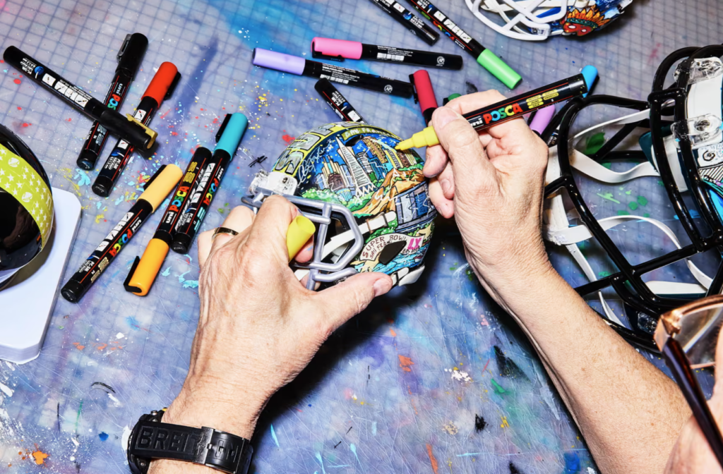 Inside Charles Fazzino’s New Rochelle studio, where he poses with some of his latest Super Bowl art. Photograph: Amy Lombard/The Guardian