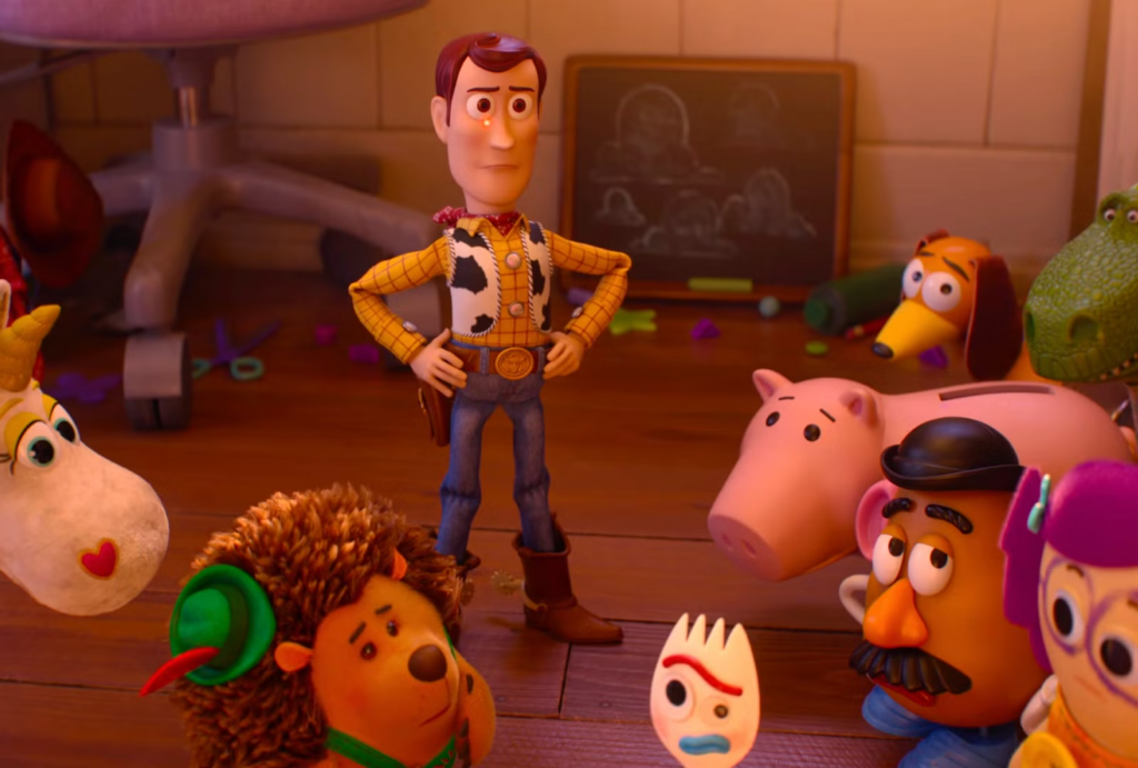 Woody stands with hands on hips, surrounded by a circle of toy friends on a wooden floor in warm light.