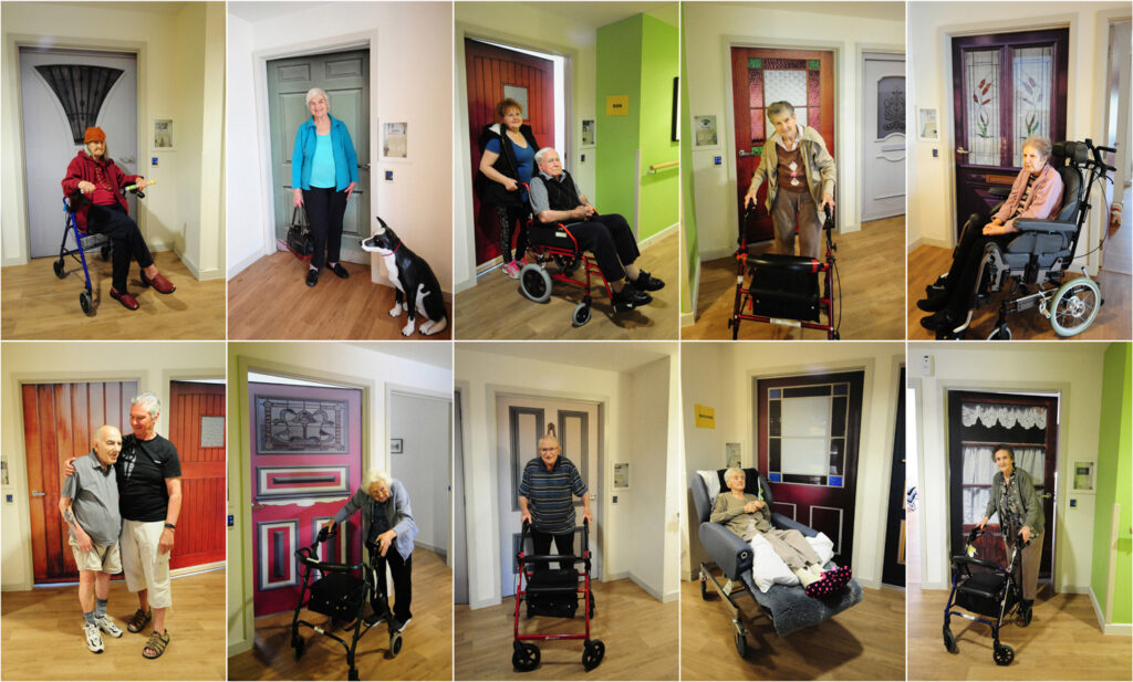 Older woman with an orange hat using a rollator in a pale yellow hallway in a care home.